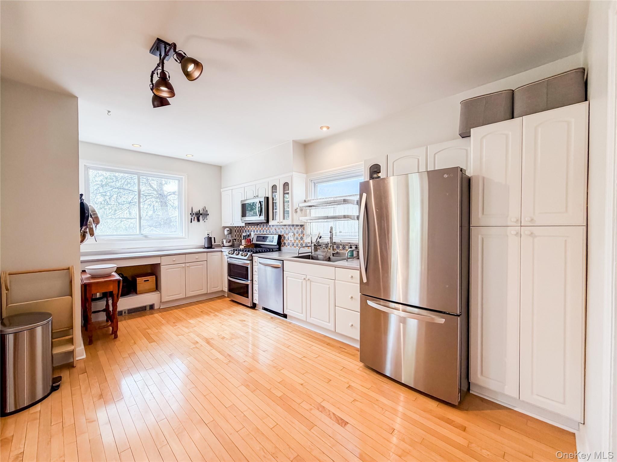 350 Smith Street Peekskill, NY 10566 - Photo 17 of 32 a kitchen with stainless steel appliances a refrigerator sink and wooden floor