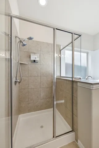 a bathroom with a glass shower door