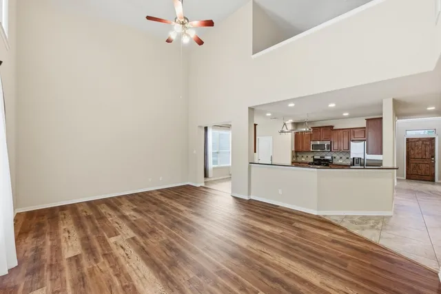 a view of a kitchen with wooden floor and a sink