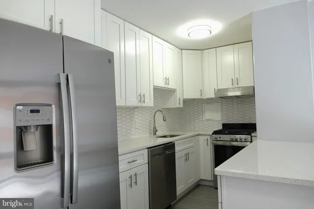 a kitchen with stainless steel appliances a refrigerator sink and stove