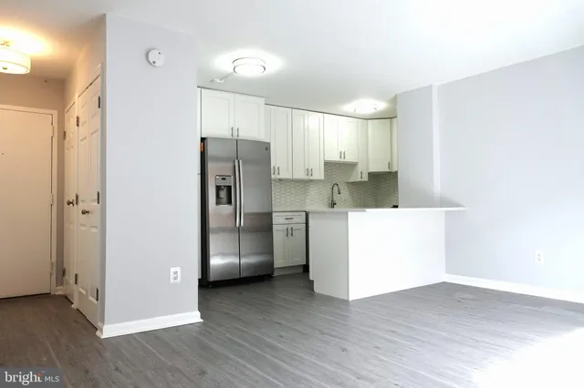 a kitchen with stainless steel appliances a refrigerator and a sink