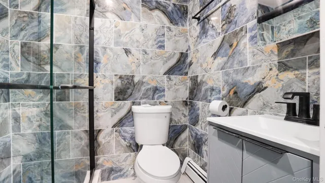 a white toilet sitting next to a bathroom sink