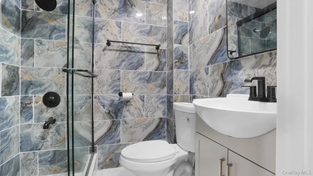 a bathroom with a sink toilet and shower