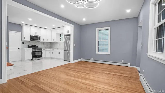a open kitchen with stainless steel appliances granite countertop a refrigerator and a sink