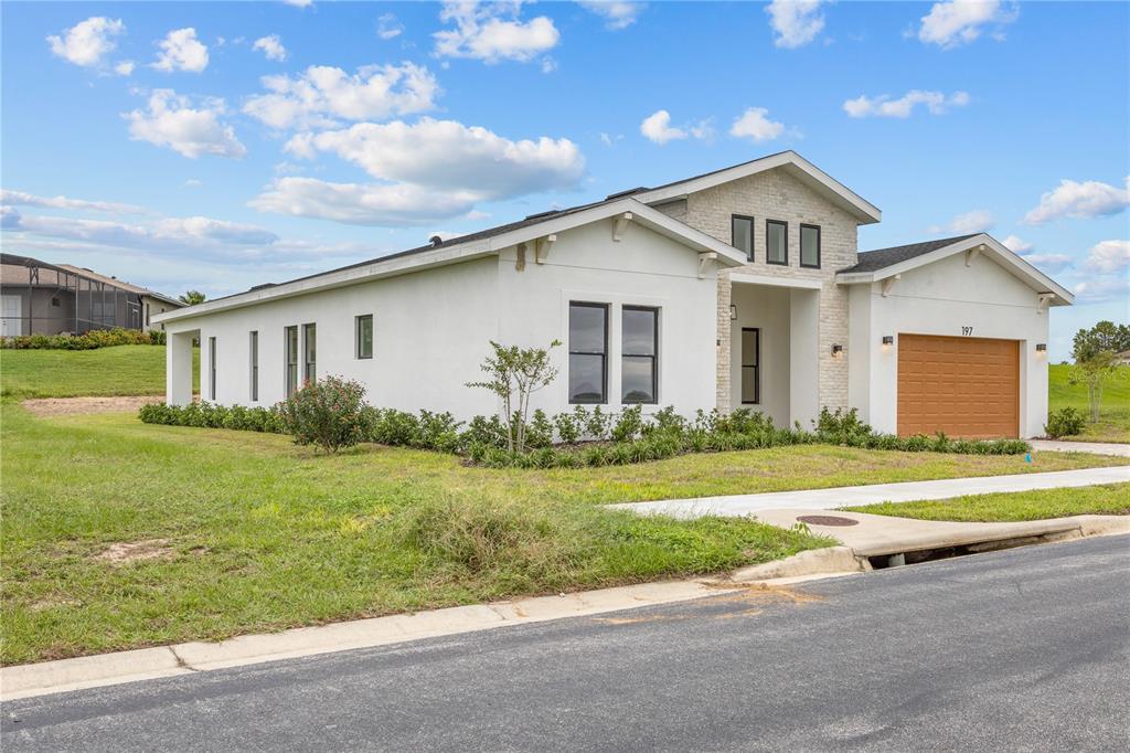 197 Valencia Ridge Drive Auburndale, FL 33823 - Photo 2 of 19 a front view of a house with a yard and garage