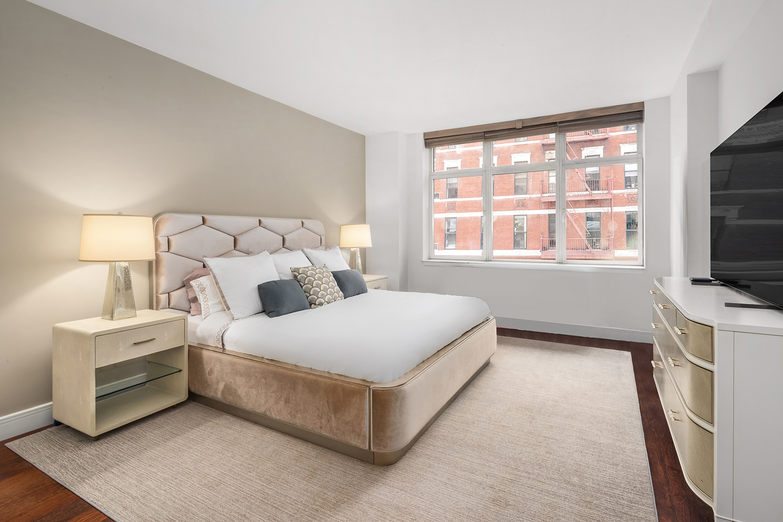 181 East 90th Street, Unit 4A Manhattan, NY 10128 - Photo 6 of 10 a bedroom with a bed flat screen tv and a window