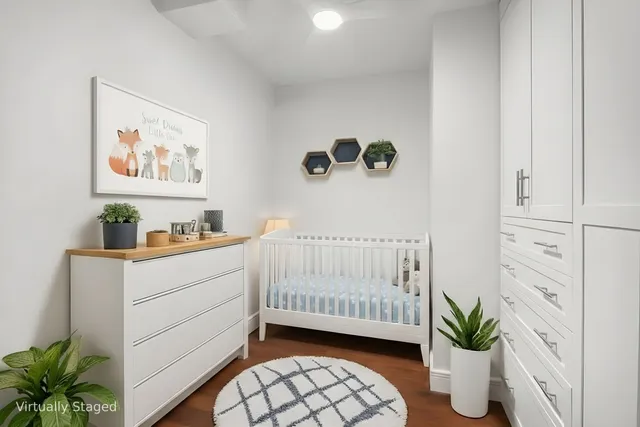 a bedroom with a bed and a potted plant