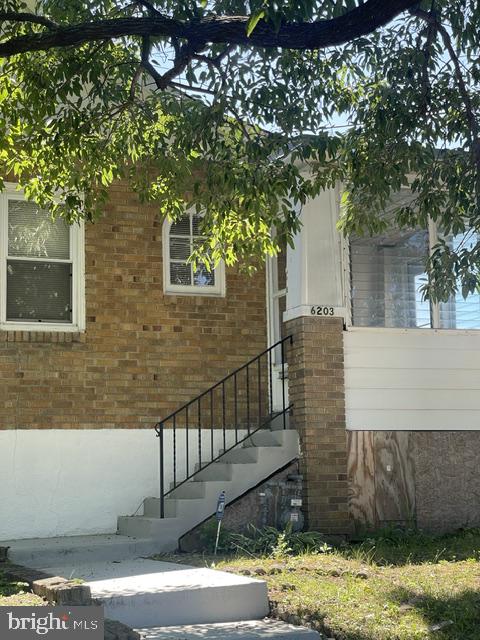 Charming brick facade with inviting steps.