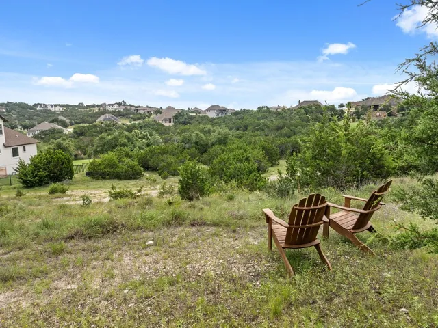 a view of a backyard with table and chairs