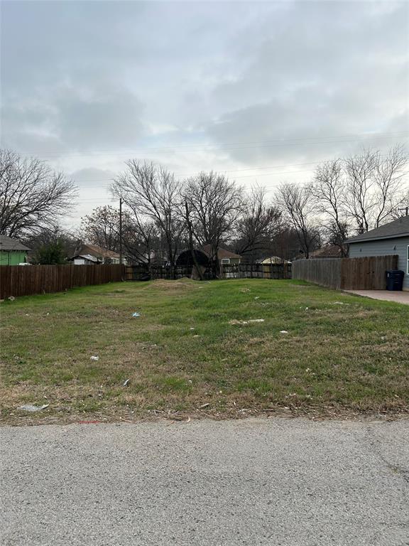 3429 Detonte Street Dallas, TX 75223 - Photo 3 of 3 a view of a garden with a building in the background