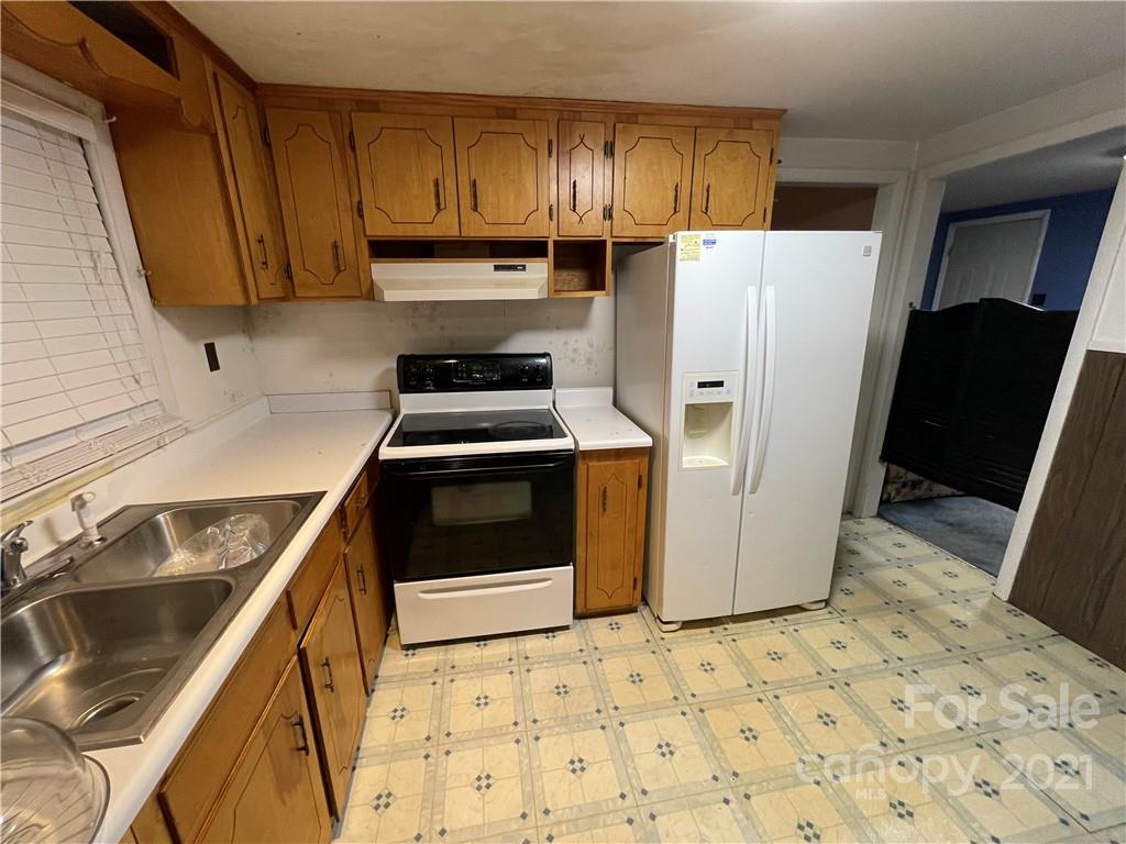 2808 Old Williams Road Raleigh, NC 27610 - Photo 5 of 16 a kitchen with a refrigerator sink and stove