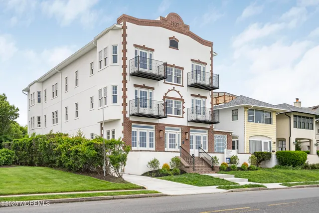a view of a white building among the yard
