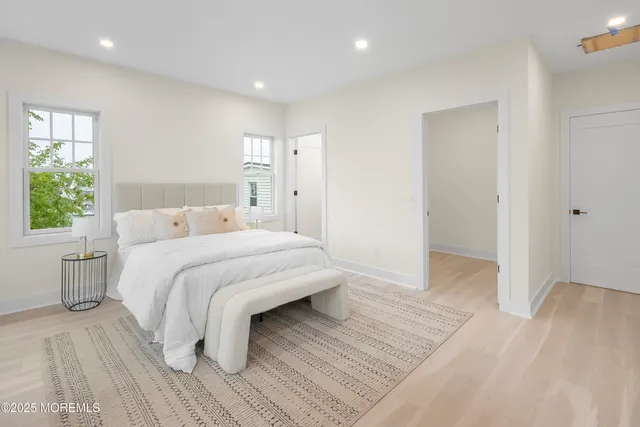 a bedroom with a bed and a large window