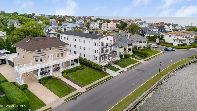an aerial view of multiple houses with a yard