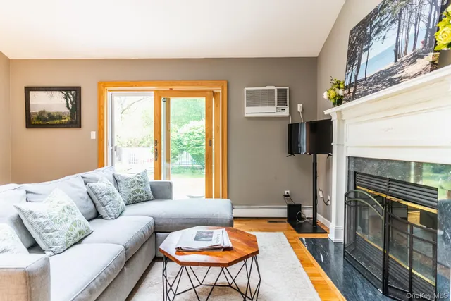 a living room with furniture a flat screen tv and a fireplace