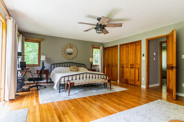 a bedroom with a large bed and a chandelier
