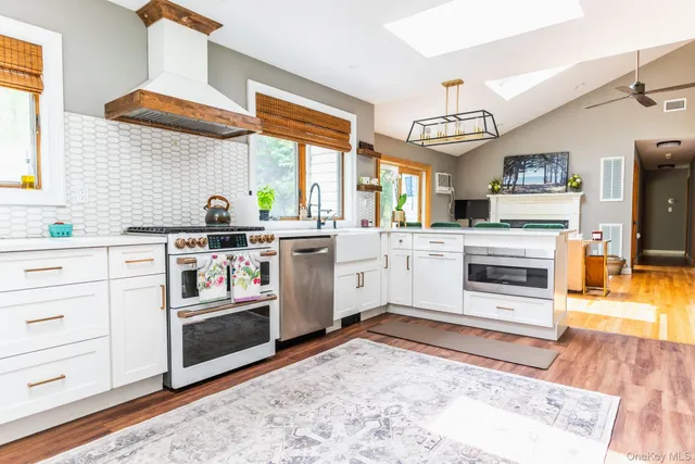a kitchen with stainless steel appliances a stove top oven and a sink