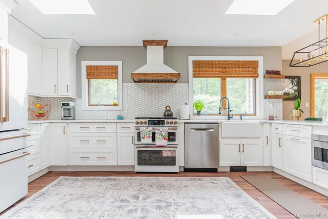 a kitchen with white cabinets and white appliances