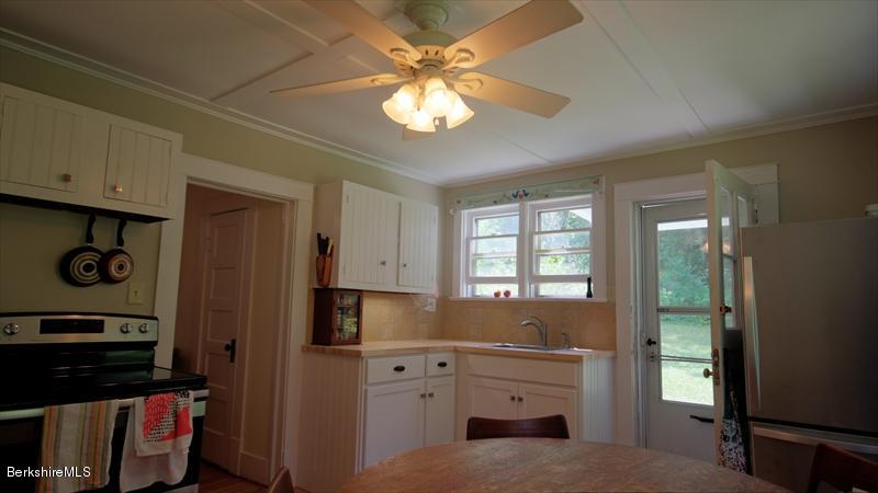 100 Fernside Road Lee, MA 01260 - Photo 5 of 18 a kitchen with cabinets appliances and a window
