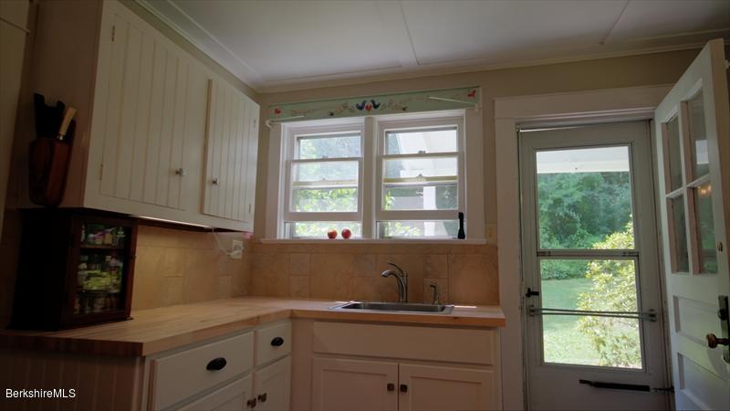 100 Fernside Road Lee, MA 01260 - Photo 6 of 18 a kitchen with a sink window and cabinets