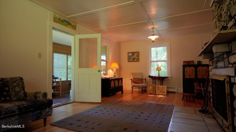100 Fernside Road Lee, MA 01260 - Photo 8 of 18 a living room with furniture a dining table and a fireplace