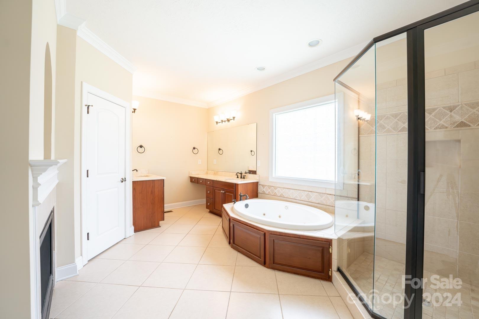 3563 Gordon Street Terrell, NC 28682 - Photo 25 of 45 a bathroom with a tub a sink a mirror and a shower