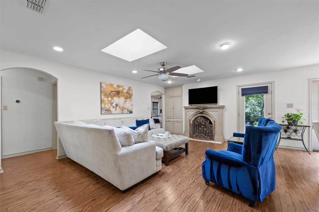 318 Ridge Creek Road Waxahachie, TX 75167 - Photo 7 of 40 Hardwood flooring, recessed lighting, skylights, ceiling fan, and an arched doorway