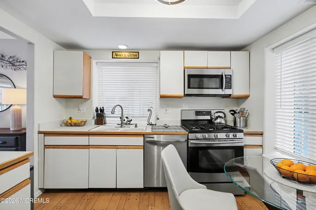 a kitchen with a sink stove and microwave
