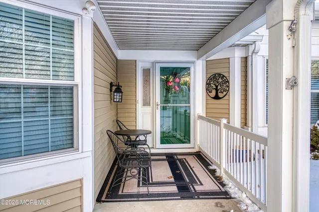 a view of a porch with furniture and floor to ceiling window