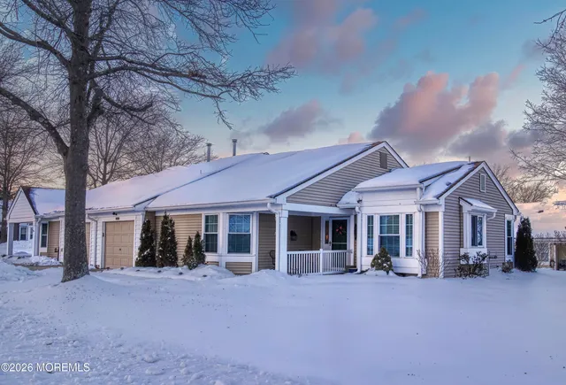 a front view of a house with a garden and porch