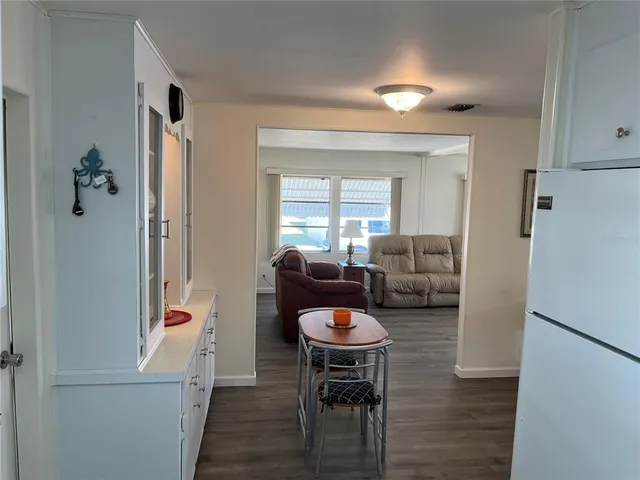a view of a dining room with furniture wooden floor and a rug