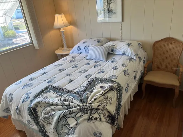 a bedroom with a bed and a chair