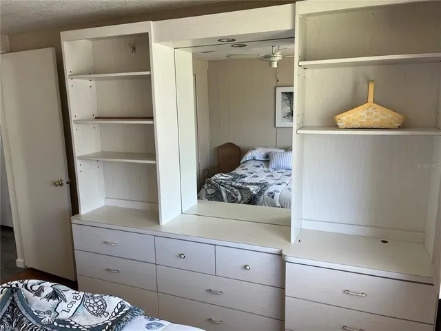 a bedroom with a bed and a cabinets