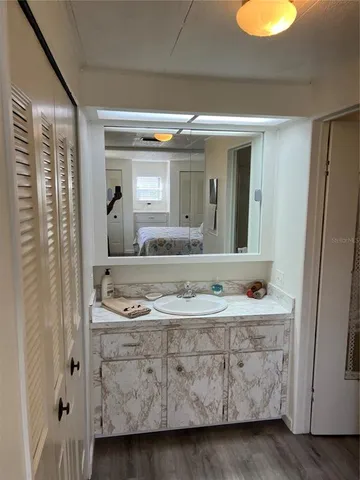 a bathroom with a granite countertop sink and a mirror