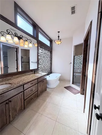 a spacious bathroom with a granite countertop sink a toilet and mirror