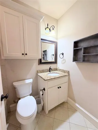 a spacious bathroom with a toilet sink and mirror