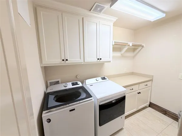 a utility room with sink dryer and washer