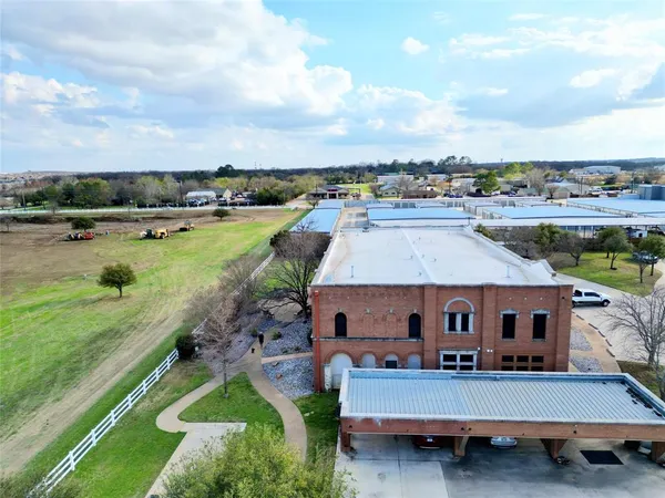 a aerial view of a house with swimming pool garden and lake view