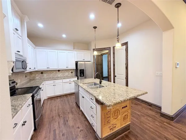 a kitchen with a stove sink and refrigerator