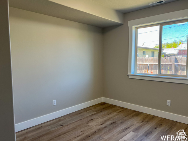 702 North 100 West Logan, UT 84321 - Photo 52 of 58 Unfurnished room with baseboards, visible vents, and wood finished floors