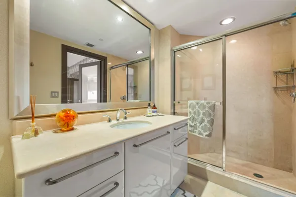 a view of a bedroom with furniture and large window