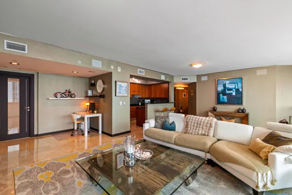 a kitchen with granite countertop a sink and a refrigerator