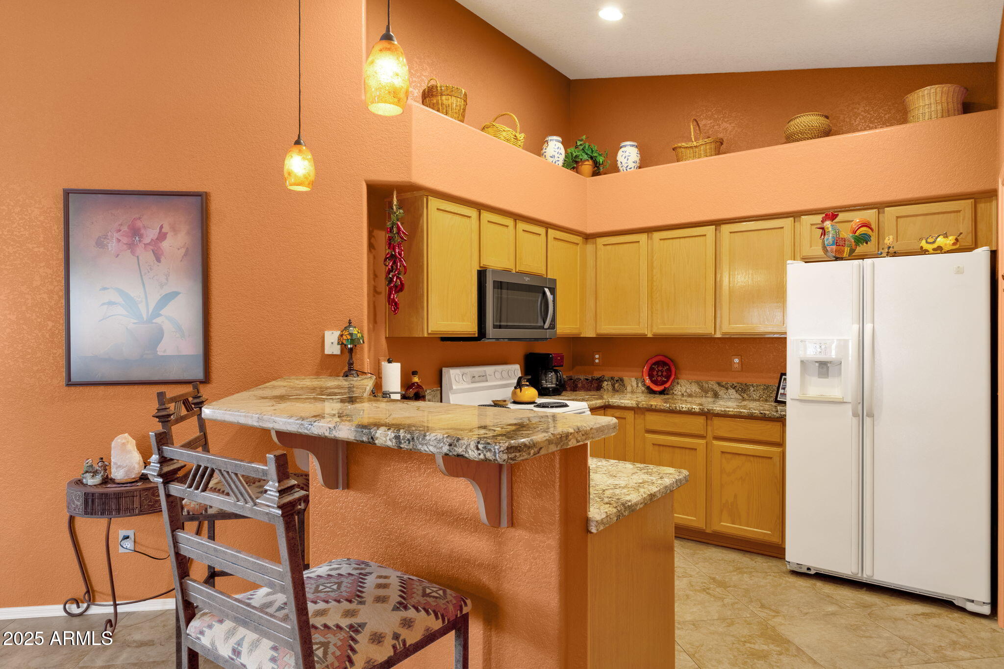 10408 West Burnett Road Peoria, AZ 85382 - Photo 14 of 30 a kitchen with a refrigerator and a stove