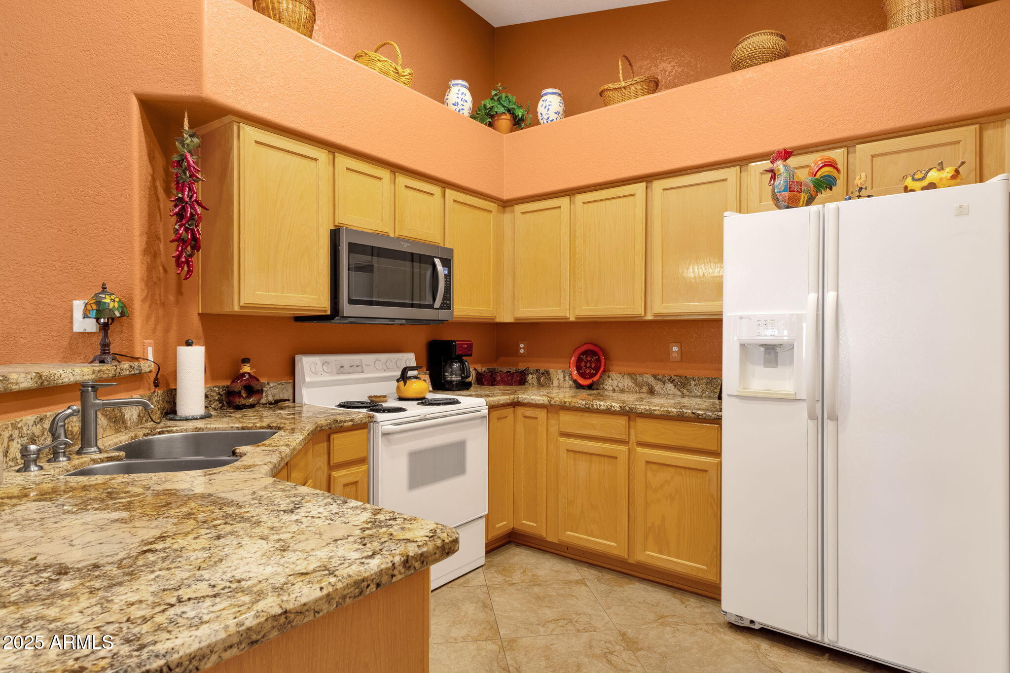10408 West Burnett Road Peoria, AZ 85382 - Photo 15 of 30 a kitchen with stainless steel appliances granite countertop a refrigerator a stove top oven a sink and dishwasher