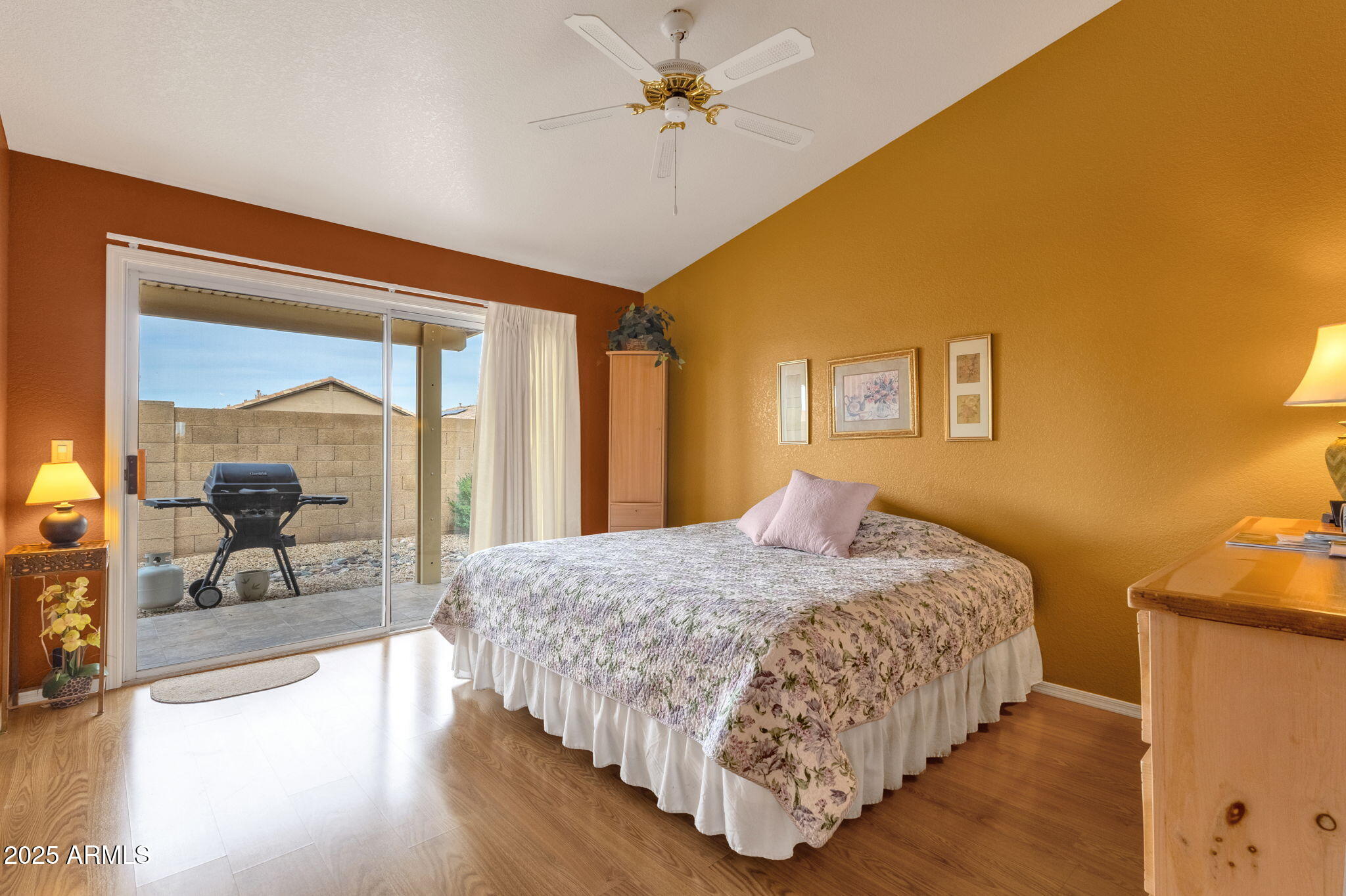 10408 West Burnett Road Peoria, AZ 85382 - Photo 22 of 30 a bedroom with a large bed and a chandelier