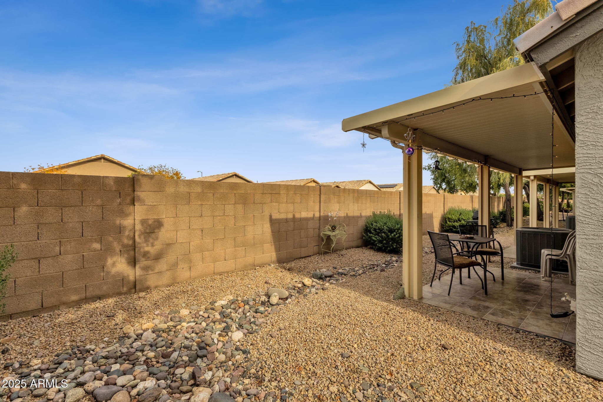10408 West Burnett Road Peoria, AZ 85382 - Photo 27 of 30 a view of a patio with a table and chairs under an umbrella