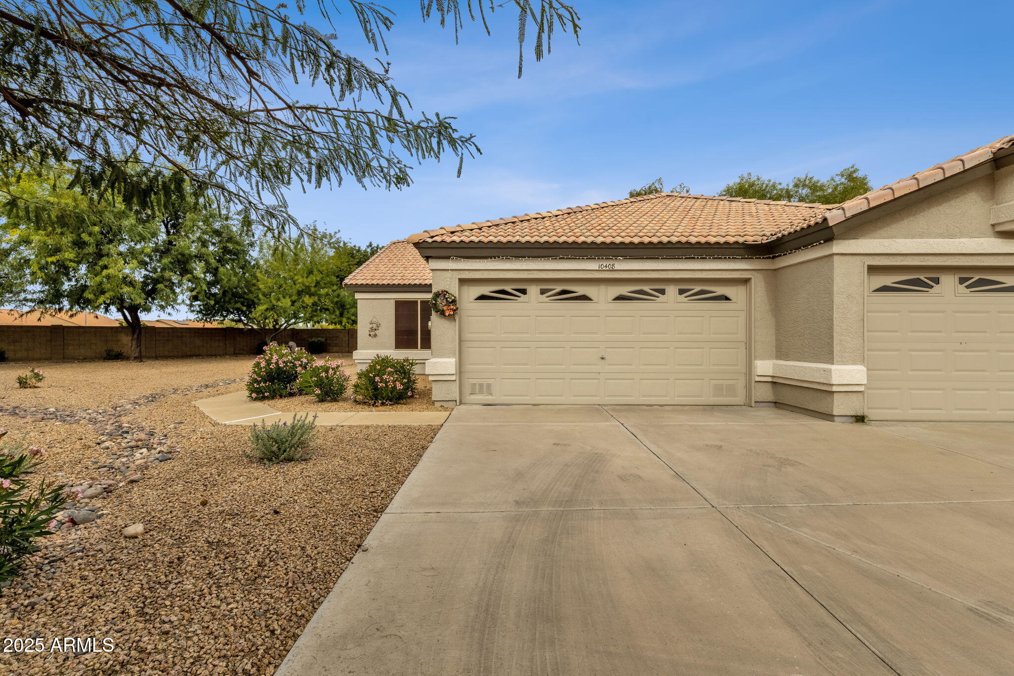 10408 West Burnett Road Peoria, AZ 85382 - Photo 3 of 30 a front view of a house with a yard and garage