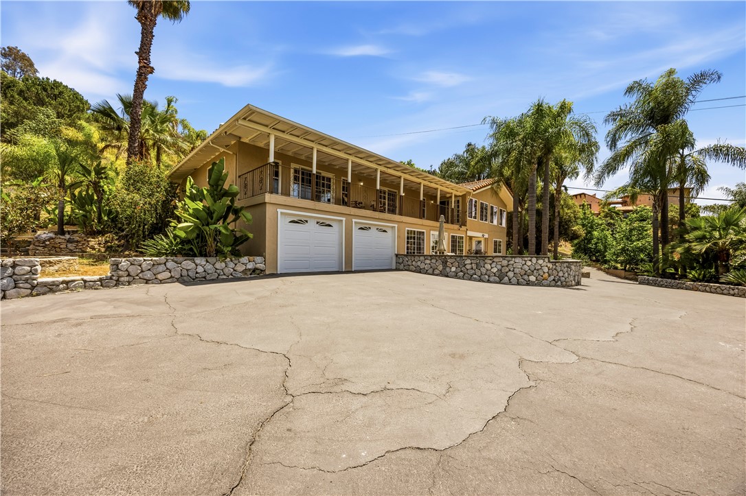 1485 Vía Ladera Fallbrook, CA 92028 - Photo 5 of 43 a front view of a building with palm trees