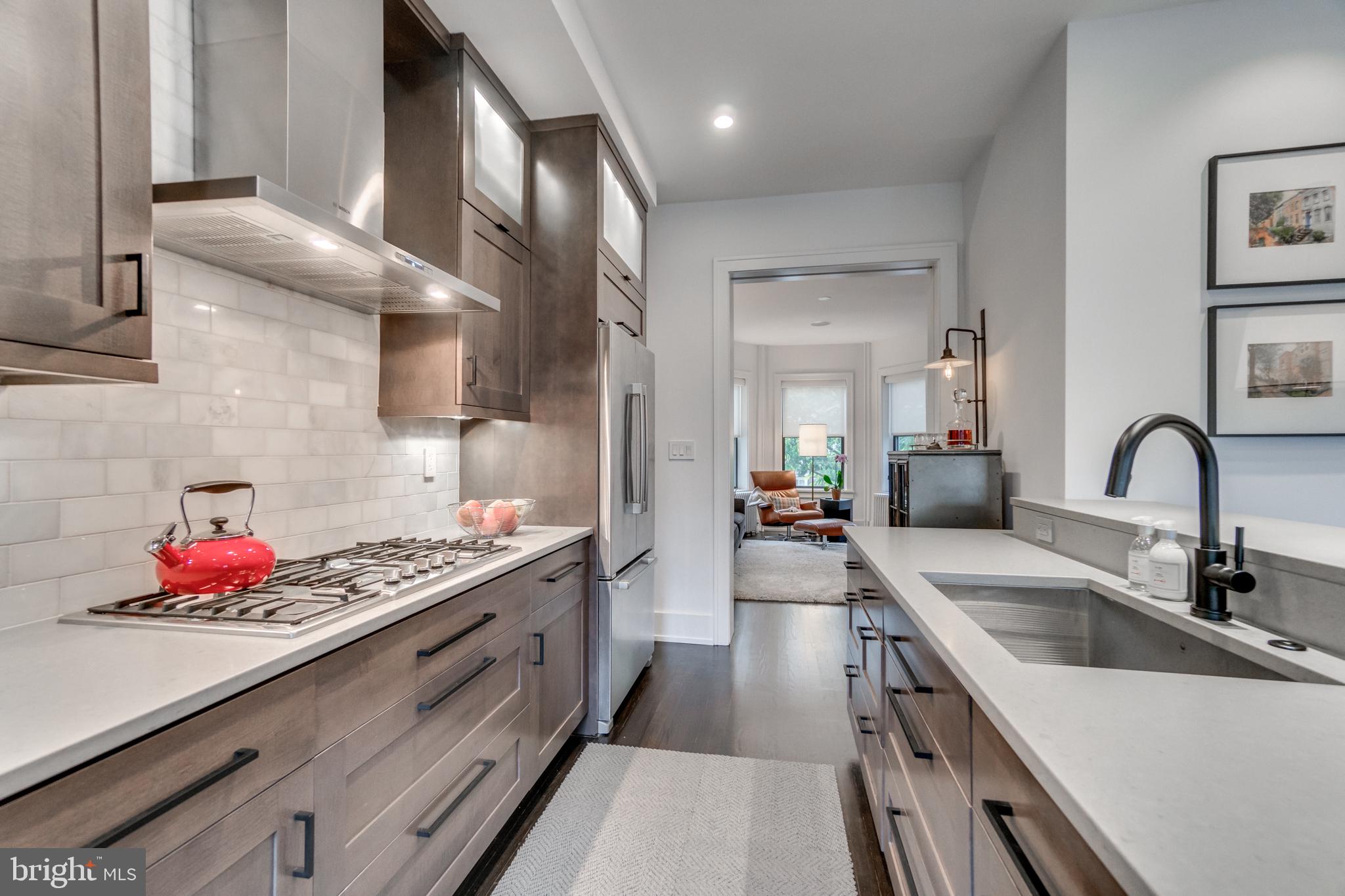 1009 Irving Street Northwest Washington, DC 20010 - Photo 11 of 33 Sleek modern kitchen with elegant finishes.