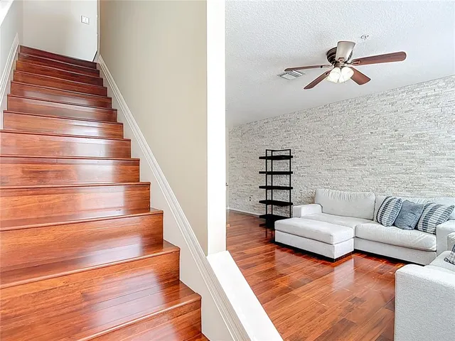 a living room with furniture and stairs